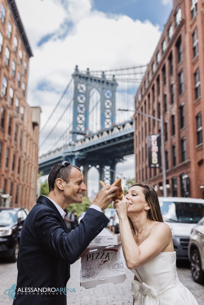 Bride and Groom eat a pizza on the street in Dumbo