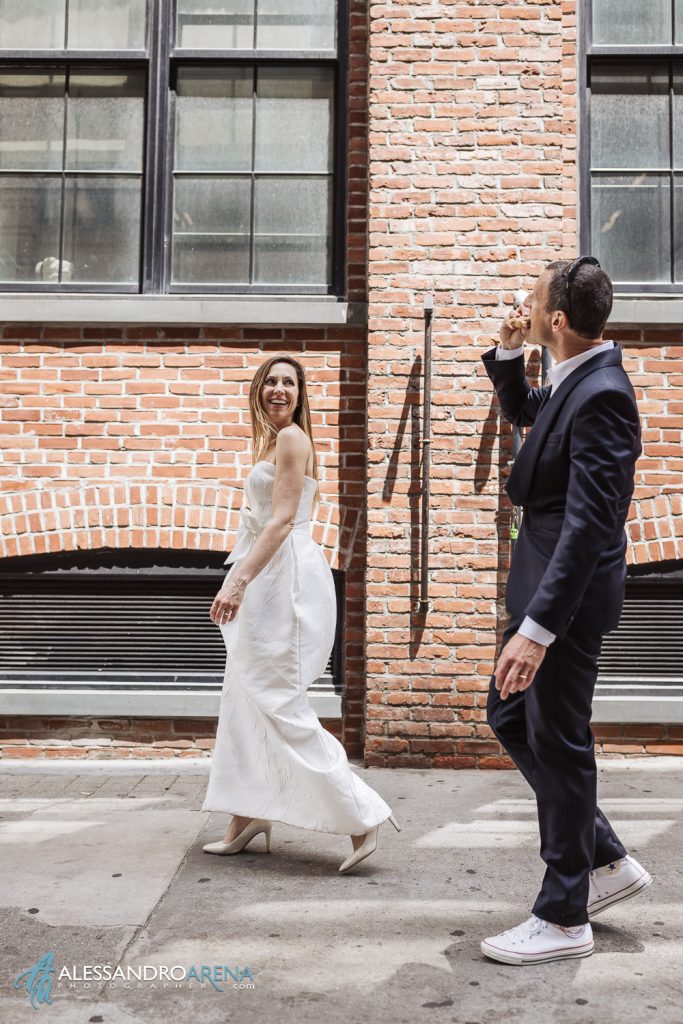 Bride and Groom eat a pizza on the street in Dumbo